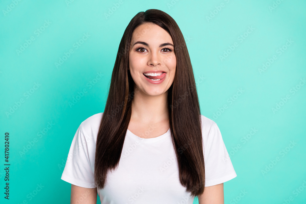 Photo of young attractive woman happy positive smile tongue lick teeth tasty hungry food isolated over teal color background Photo of young attractive woman happy positive smile tongue lick teeth tasty hungry food isolated over teal color background