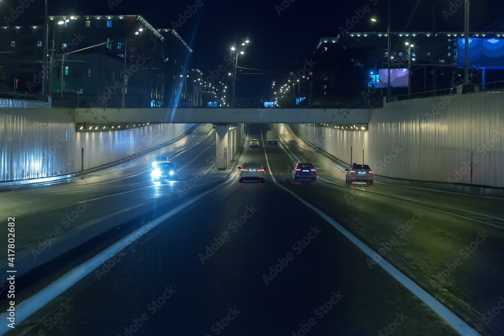 Car traffic at night in a tunnel on junction in the city. Car traffic at night in a tunnel on junction in the city.