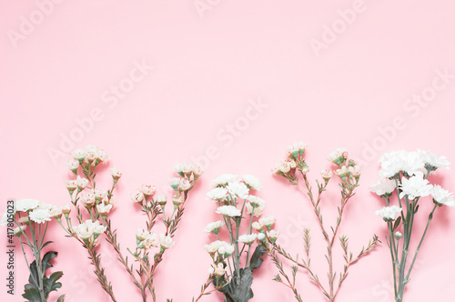 Flowers on a pink background arranged in a line from the bottom. The template is floral.
