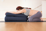 Pregnant woman is engaged in yoga. Wide Legged Child Pose or Balasana