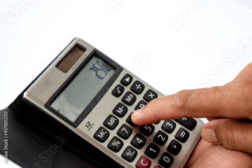 Close up photo of finger and calculator to calculate economy and finance photo