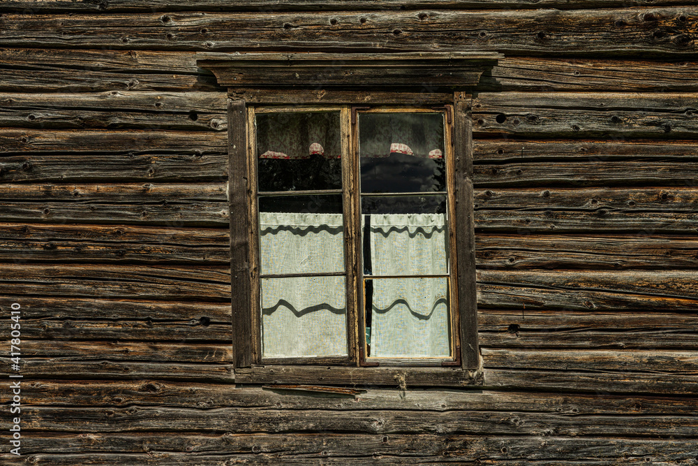 Old skewed window in a timber wall Old skewed window in a timber wall
