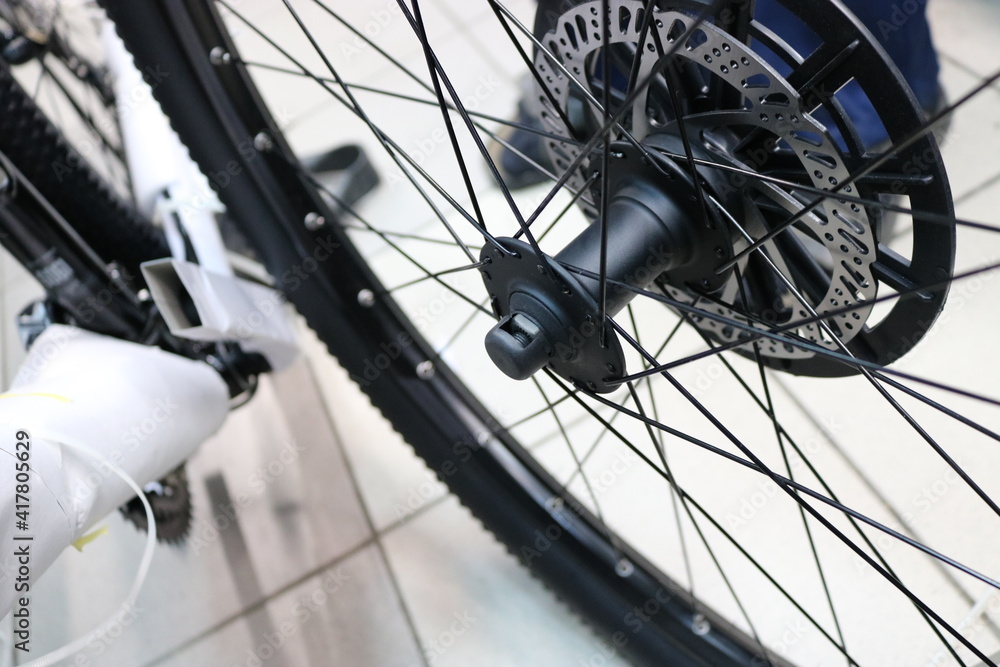 New bicycle wheel with disc brakes at a sports store. Pre-sale preparation. New bicycle wheel with disc brakes at a sports store. Pre-sale preparation.