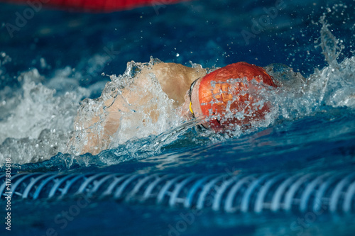 Swimming crawl sportsman with splashes