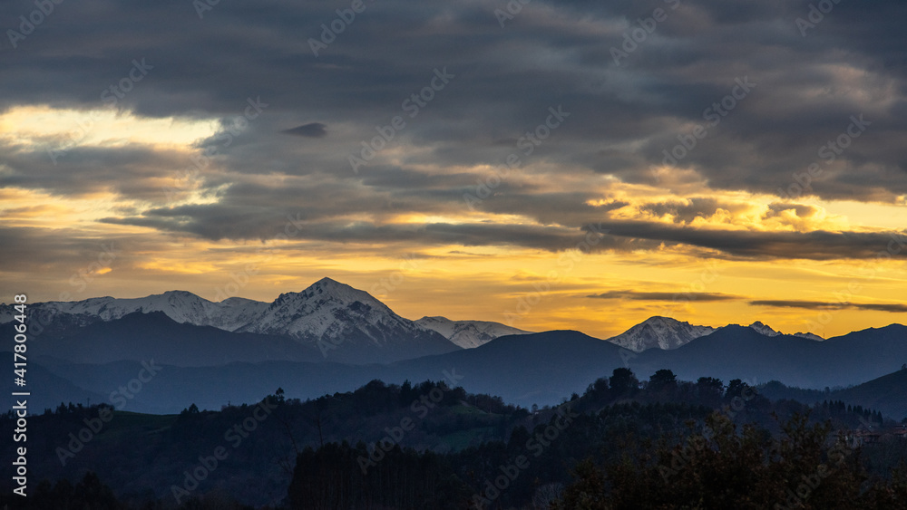 beautiful sunset in the mountains with beautiful colors in a natural environment with trees