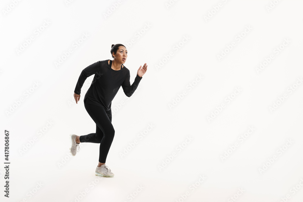 Focused african american woman running while working out Focused african american woman running while working out