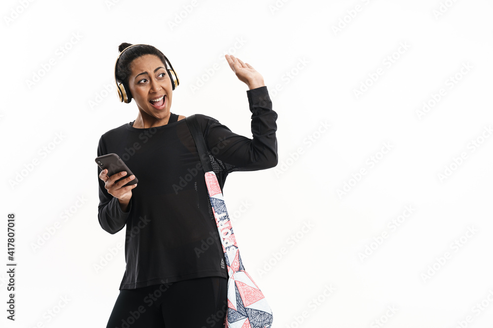 Smiling african american woman waving hand while using cellphone Smiling african american woman waving hand while using cellphone