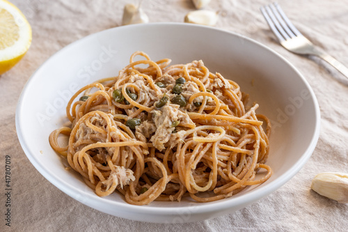 Spaghetti with tuna and capers. Typical Italian pasta dish with tuna.