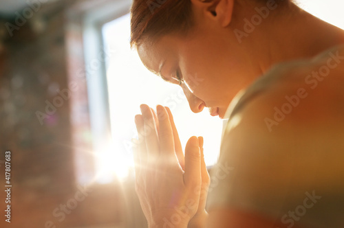 Obraz na plátně religion, faith and people concept - close up of woman meditating at yoga studio