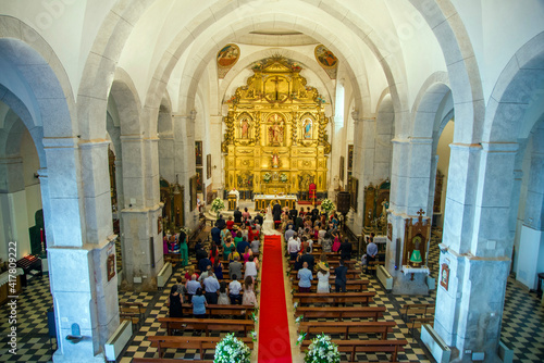 CHURCH INTERIOR DURING A WEDDING CELEBRATION