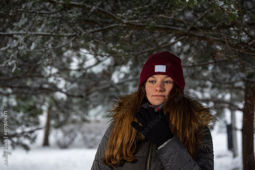 Girl in the winter, against the background of snow-covered trees Girl in the winter, against the background of snow-covered trees