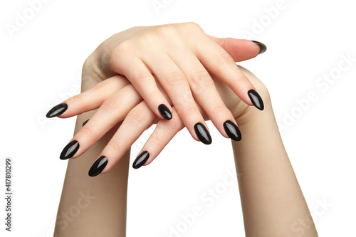 Female hands with black nails manicure isolated on white background.