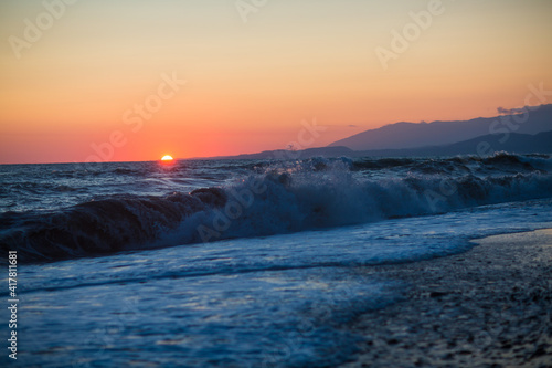 Fototapeta Naklejka Na Ścianę i Meble -  beautiful sunset by the sea with strong waves