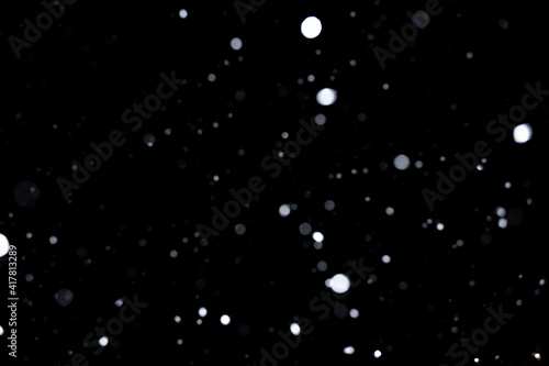 Element for winter design or overlay. Real snow over black background.