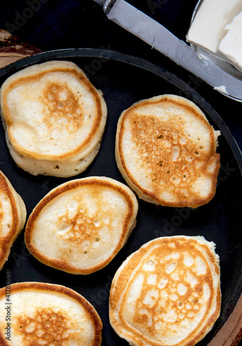 Small banana pancakes on a frying pan