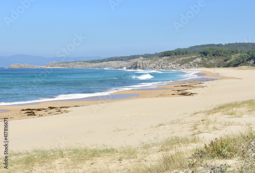 Wild beach with waves breaking, view from sand dunes. Rias Baixas region, Porto do Son, Coruña, Galicia, Spain.