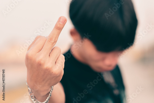 Young man raising his middle finger