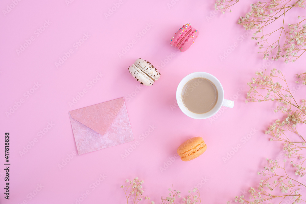 Cup of coffee and colorful macaron on pastel pink background top view. Cozy breakfast. Fashion flat lay. Sweet macaroons. Cup of coffee and colorful macaron on pastel pink background top view. Cozy breakfast. Fashion flat lay. Sweet macaroons.