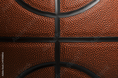 Closeup detail of basketball ball texture background. Team sport concept. Sports background for product display, banner, or mockup. © Augustas Cetkauskas