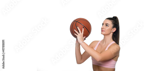 Portrait of a beautiful and girl with a basketball in studio. Sport concept isolated on white background. Sports background for product display, banner, or mockup.