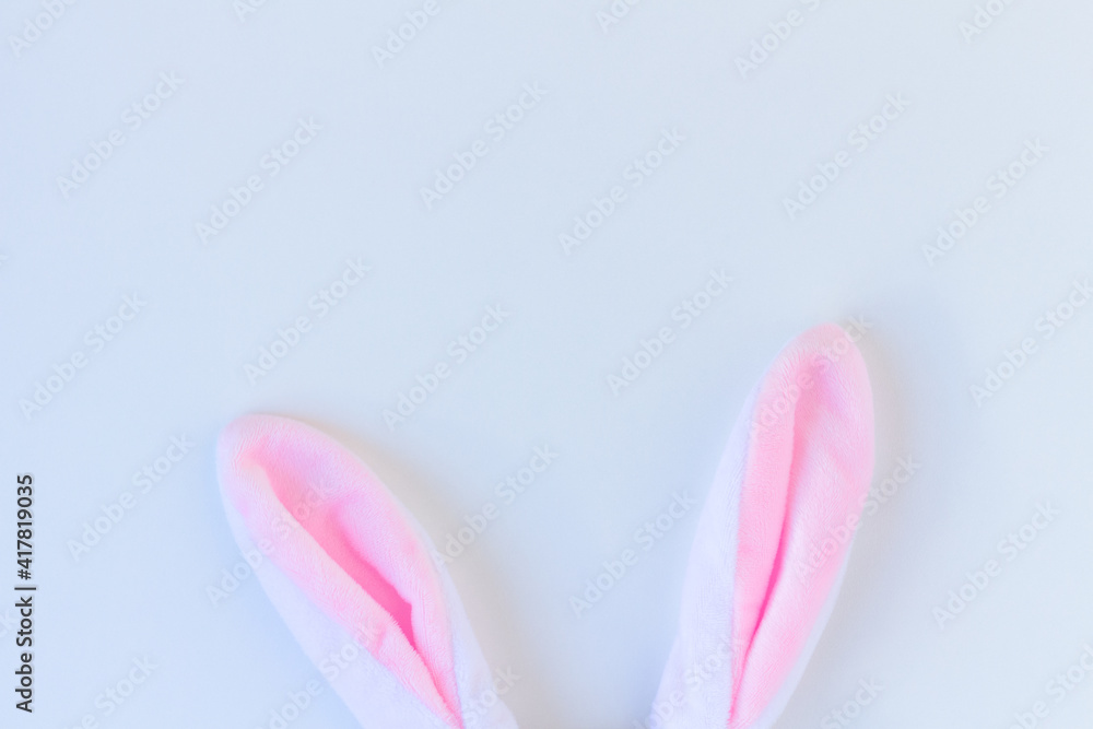 Plush rabbit ears on white background. Minimalist Happy Easter concept. Free space to design. Plush rabbit ears on white background. Minimalist Happy Easter concept. Free space to design.