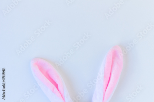 Plush rabbit ears on white background. Minimalist Happy Easter concept. Free space to design.
