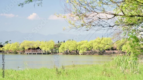 Beautiful lakescape on a sunny day with the sunlight and breeze. photo