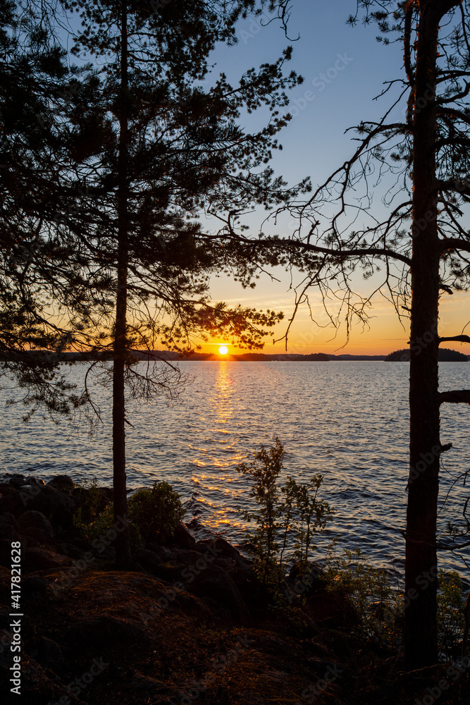 View of the shore of The Lammassaari island and the sunset on The Lake Saimaa, Imatra, Finland