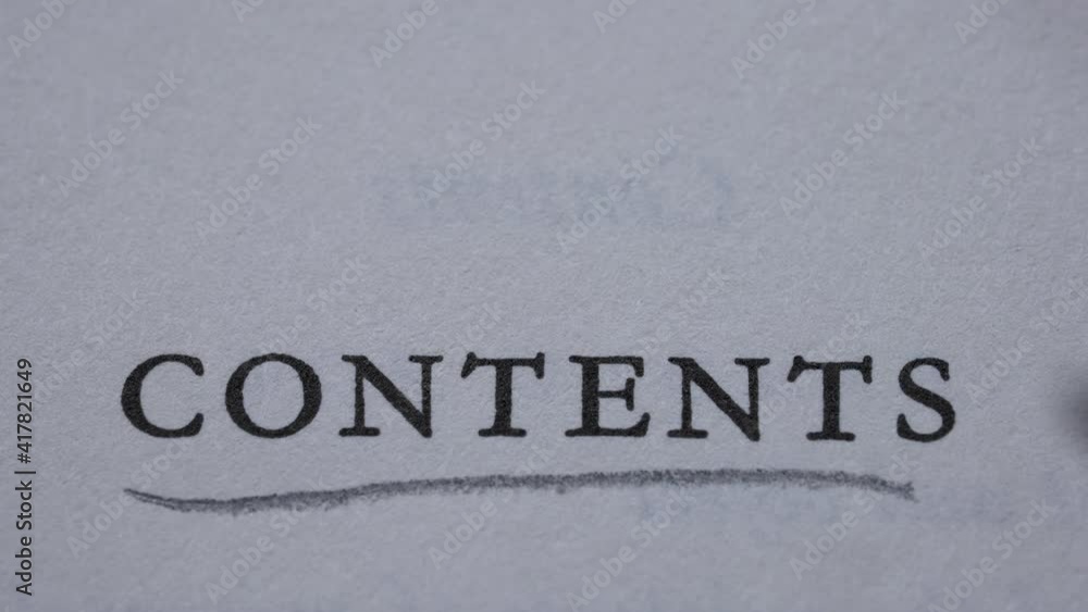 Open book on a page with contents. Man underlines the word contents in slow motion with a pencil. Close up. Open book on a page with contents. Man underlines the word contents in slow motion with a pencil. Close up.
