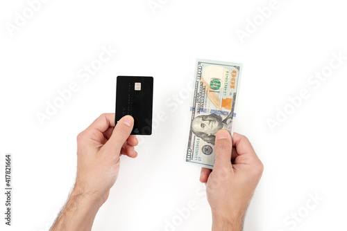 Men's hands holding credit or debit card and one hundred banknote. Finance and wealthy concept