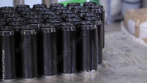 Closed beer cans are placed on a pallet. Brewing process