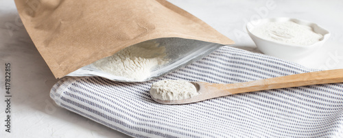 Crumbly xanthan gum in a wooden spoon.