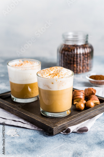 Homemade cappuccino with almond milk and cinnamon. Freshly brewed coffee for two for breakfast. Aromatic coffee