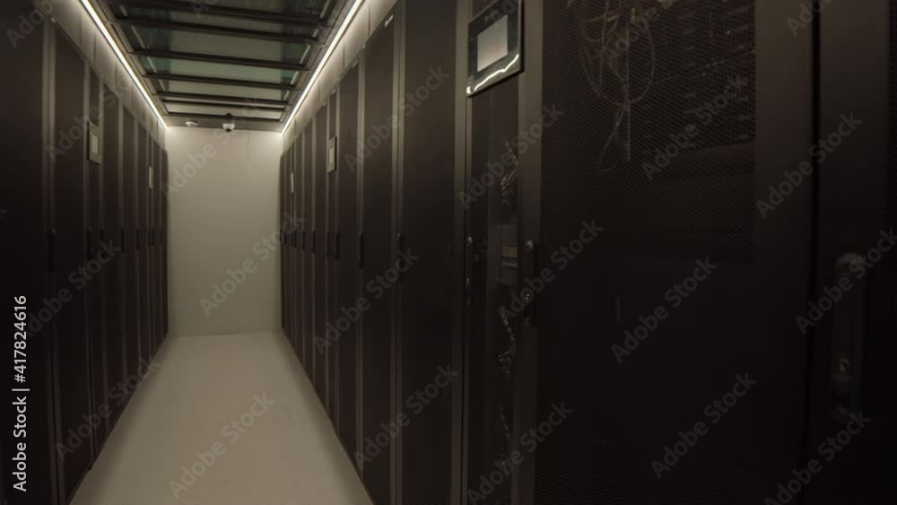 Wide shot of rows of rack server cabinets with mainframes and no people in modern data center Wide shot of rows of rack server cabinets with mainframes and no people in modern data center