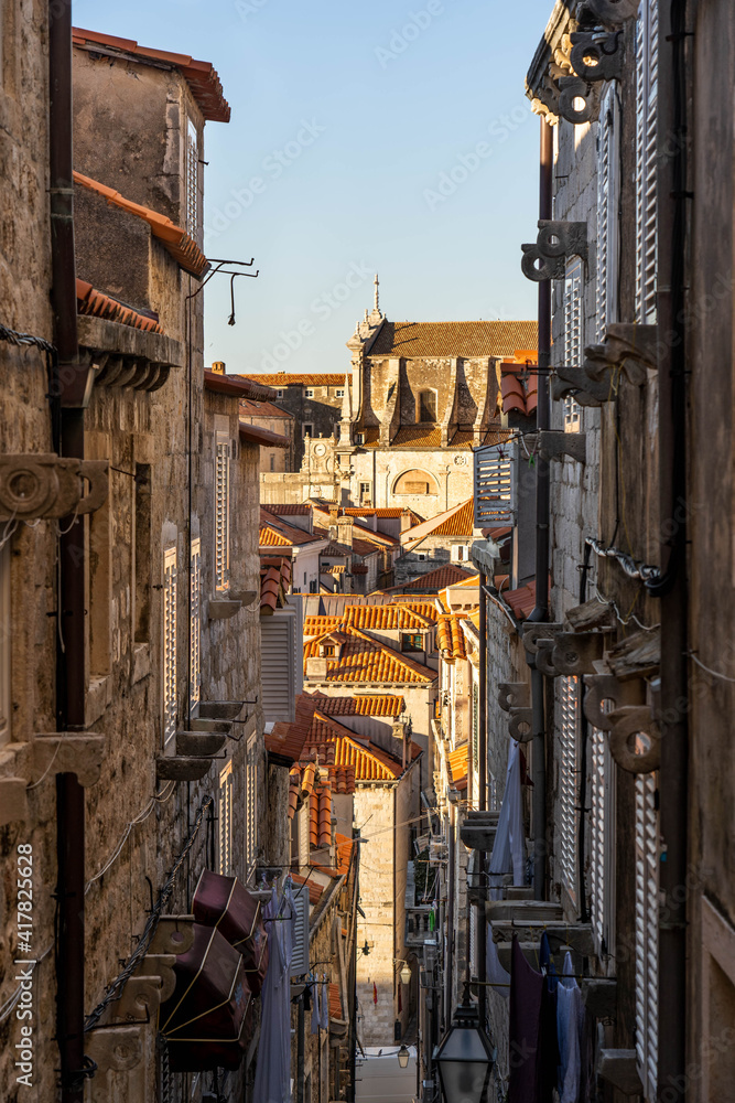 Narrow stone stairway to centeral Dubrovnik old town with view of St. Blaise church in Croatia summer morning