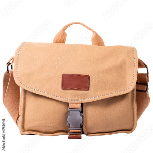 A large men's bag made of light orange fabric. Bag with flap and metal lock. One handle and a wide textile shoulder strap.
