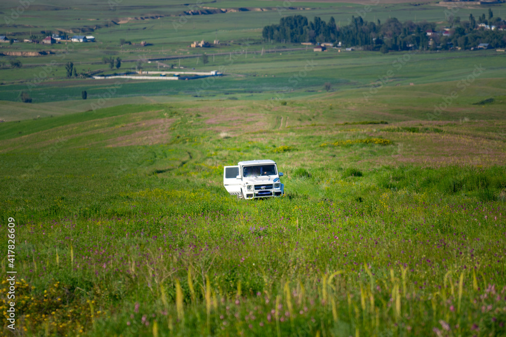 car in the field. white jeep stuck in the field. car in the field. white jeep stuck in the field.