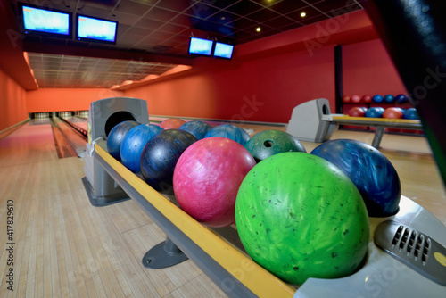 Bowling balls and wooden lane in bowling hall