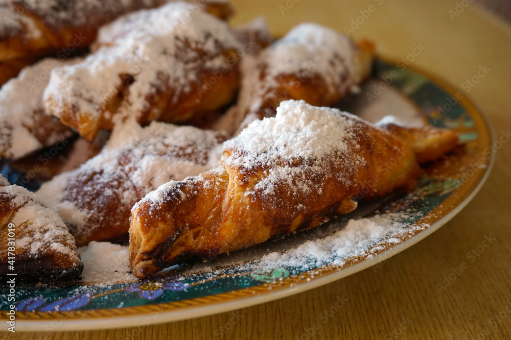 baked croissants with powdered sugar