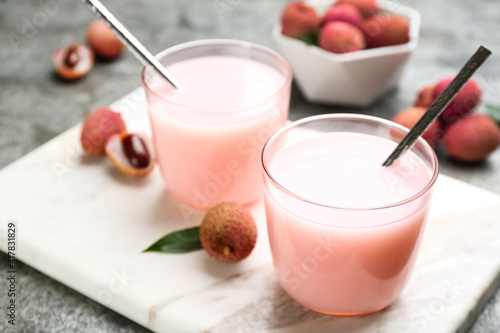 Delicious lychee cocktails and fresh fruits on white marble board