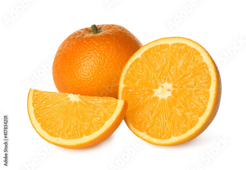 Delicious cut and whole fresh ripe oranges on white background