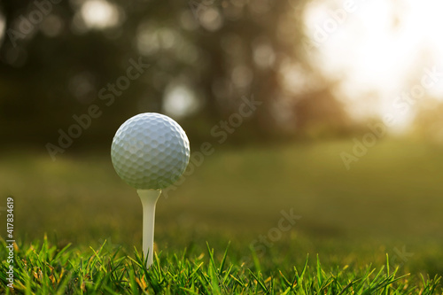 golf ball on tee in a beautiful golf course with morning sunshine