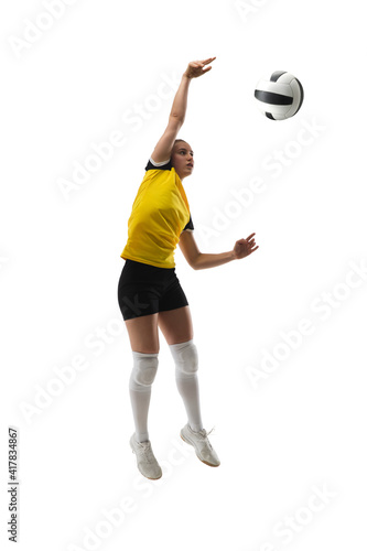 In jump. Young female volleyball player isolated on white studio background. Woman in sportswear training and practicing in action, flight. Concept of sport, healthy lifestyle, motion and movement.