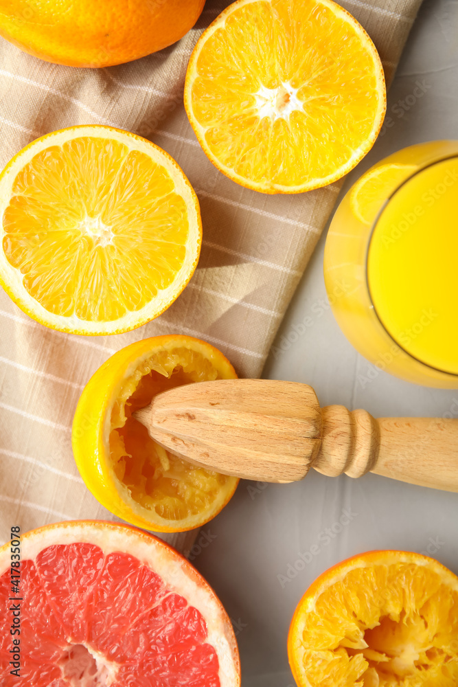 Flat lay composition with oranges and reamer on light grey table Flat lay composition with oranges and reamer on light grey table