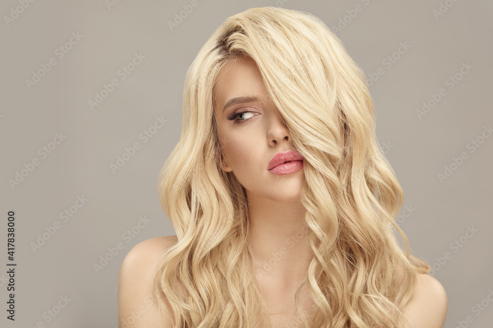 Blonde european woman with curly hair, beauty model on beige isolated Blonde european woman with curly hair, beauty model on beige isolated