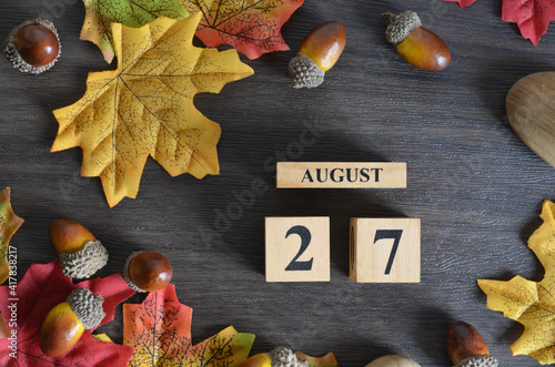 August 27, Cover Date design with Calendar cube decorate with maple leaf and Acorn Oak seed for your business.