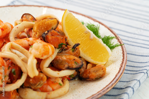 Stir fried seafood with sauce on plate with napkin