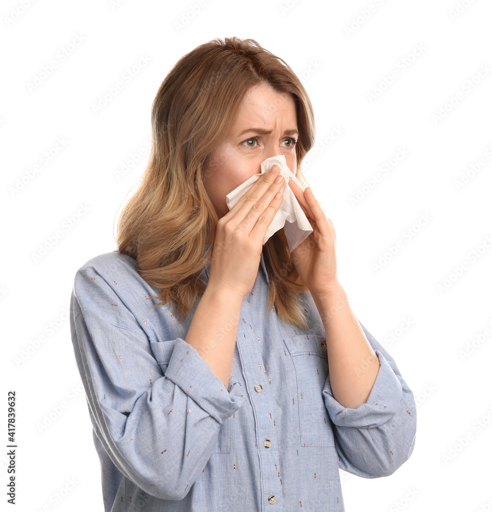 Woman with tissue suffering from runny nose on white background Woman with tissue suffering from runny nose on white background