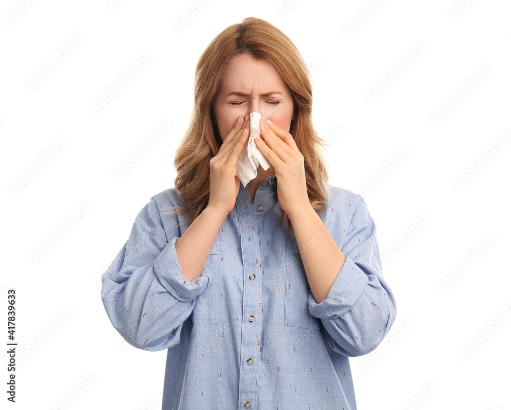 Woman with tissue suffering from runny nose on white background Woman with tissue suffering from runny nose on white background