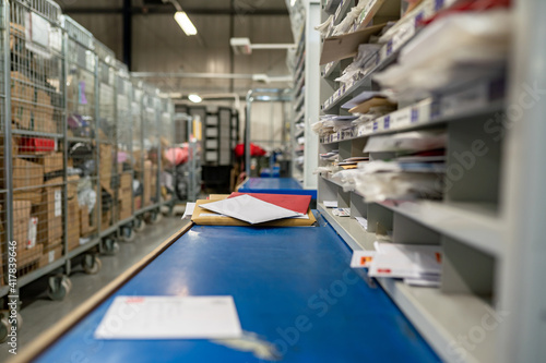 Letters on a sorting frame, table and shelves in a mail delivery sorting centre. Postal service, post office inside